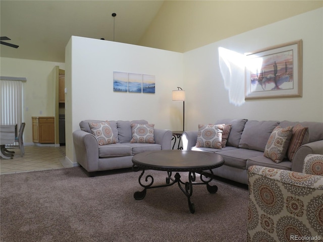 living area with light carpet, baseboards, high vaulted ceiling, and light tile patterned floors
