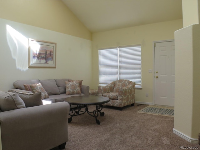 living room featuring lofted ceiling and carpet
