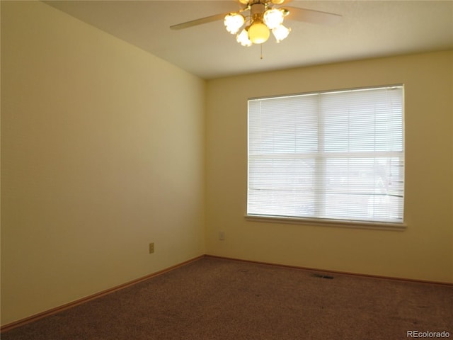 empty room with baseboards, a ceiling fan, and carpet flooring