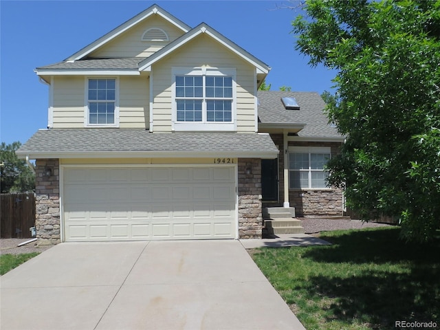 19421 E Evans Dr, Aurora, CO 80013 - view of front of property featuring roof with shingles, stone siding, a garage, and concrete driveway