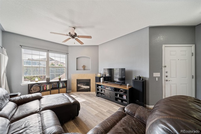 10787 Twenty Mile Rd Unit 205, Parker, CO 80134 - living area with wood finished floors, ceiling fan, and a fireplace