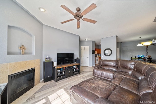 10787 Twenty Mile Rd Unit 205, Parker, CO 80134 - living room with a ceiling fan, light wood-style flooring, and a fireplace