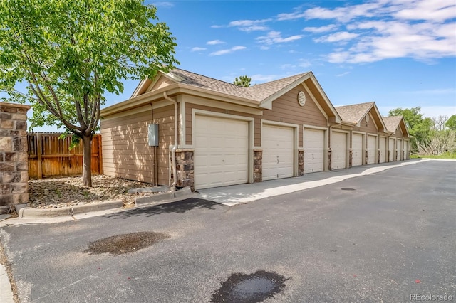 10787 Twenty Mile Rd Unit 205, Parker, CO 80134 - view of side of property with community garages and roof with shingles