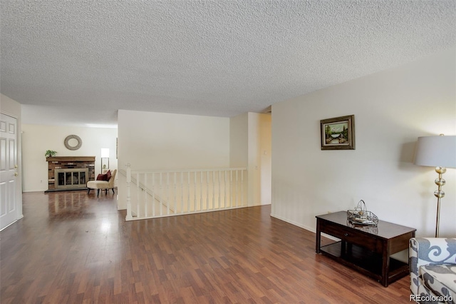10883 Otis Cir, Westminster, CO 80020 - living room featuring wood finished floors, a textured ceiling, and a fireplace