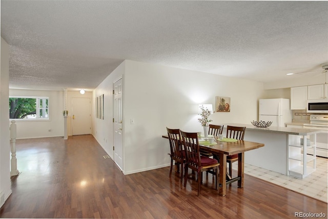 10883 Otis Cir, Westminster, CO 80020 - dining room featuring a textured ceiling, wood finished floors, and ceiling fan