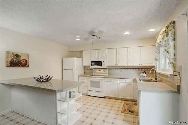 10883 Otis Cir, Westminster, CO 80020 - kitchen with white appliances, open shelves, light flooring, white cabinetry, and recessed lighting