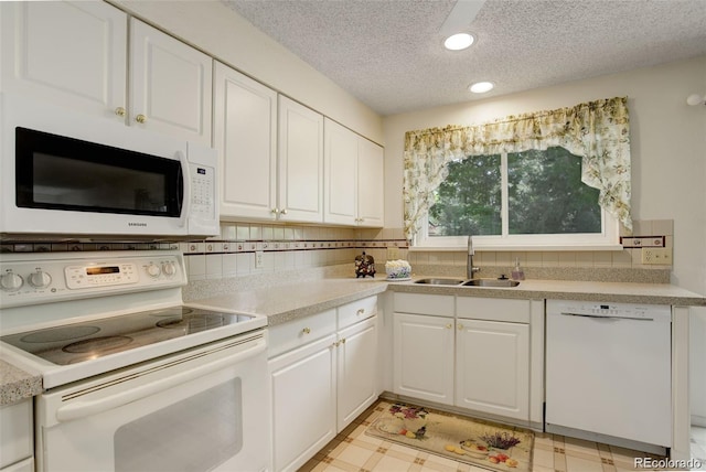 10883 Otis Cir, Westminster, CO 80020 - kitchen with white appliances, a textured ceiling, white cabinetry, light floors, and light countertops