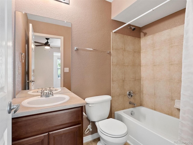 full bathroom with shower / bath combination with curtain, ceiling fan, toilet, and vanity