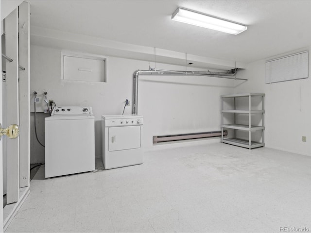 laundry area featuring light floors, baseboard heating, washing machine and clothes dryer, and laundry area