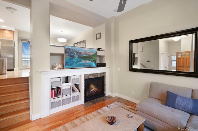 1544 Cottonwood Ave, Lafayette, CO 80026 - living room with a high end fireplace, baseboards, ceiling fan, and wood finished floors
