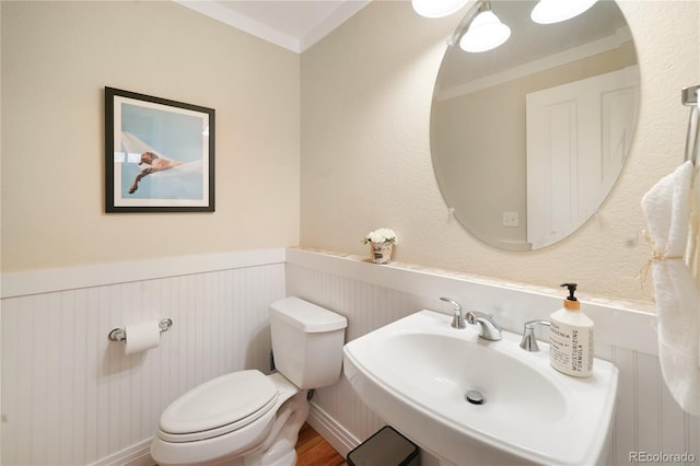 1544 Cottonwood Ave, Lafayette, CO 80026 - half bathroom with a sink, a wainscoted wall, toilet, and wood finished floors