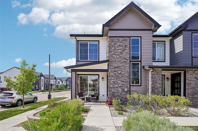 19733 W 93rd Ln Unit A, Arvada, CO 80007 - view of front facade featuring stone siding and a residential view