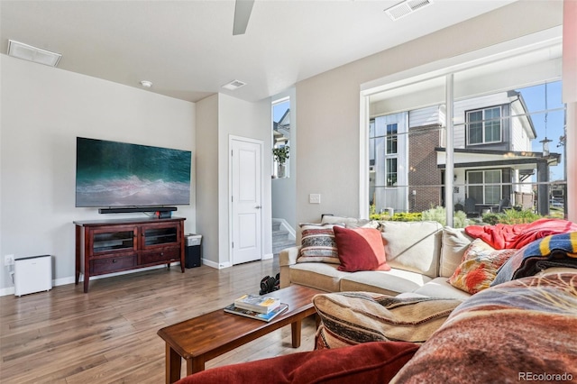 19733 W 93rd Ln Unit A, Arvada, CO 80007 - living area with wood finished floors, baseboards, and a ceiling fan
