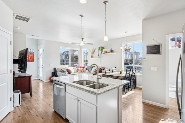19733 W 93rd Ln Unit A, Arvada, CO 80007 - kitchen with a sink, dishwasher, hardwood / wood-style flooring, a center island with sink, and healthy amount of natural light