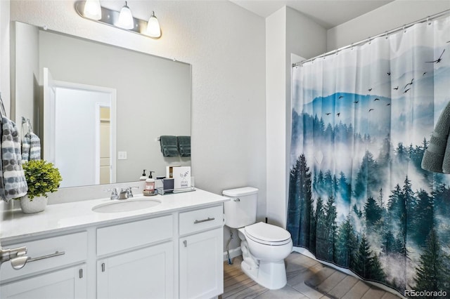 19733 W 93rd Ln Unit A, Arvada, CO 80007 - bathroom with vanity, toilet, a shower with shower curtain, and wood finished floors