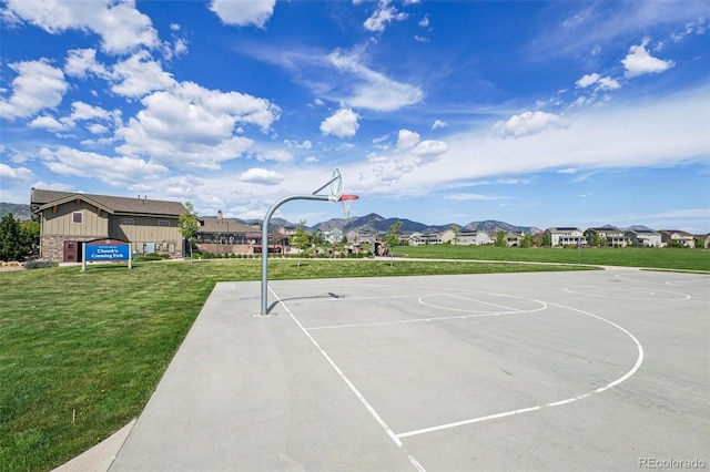 19733 W 93rd Ln Unit A, Arvada, CO 80007 - view of sport court featuring a yard, a mountain view, and community basketball court