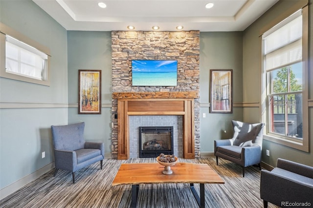 19733 W 93rd Ln Unit A, Arvada, CO 80007 - carpeted living room with a tile fireplace, a tray ceiling, baseboards, and recessed lighting