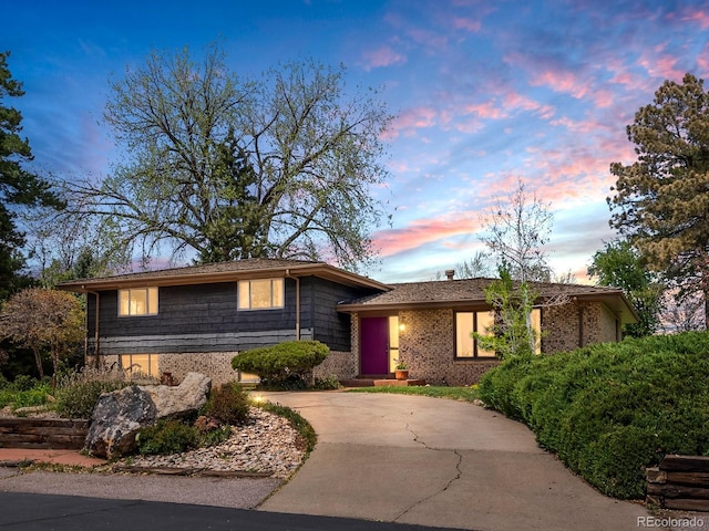 5503 W Colorado Ave, Lakewood, CO 80232 - tri-level home featuring curved driveway and brick siding