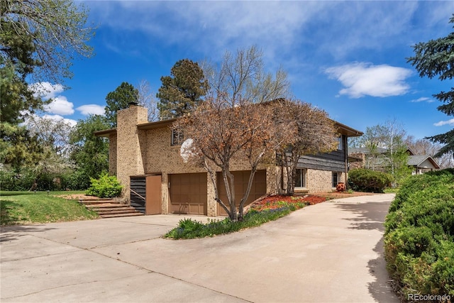 5503 W Colorado Ave, Lakewood, CO 80232 - view of front of home with a garage, a chimney, driveway, and brick siding