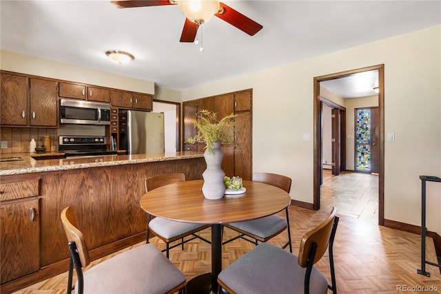 5503 W Colorado Ave, Lakewood, CO 80232 - dining space with baseboards and ceiling fan
