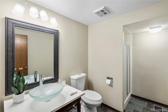 5503 W Colorado Ave, Lakewood, CO 80232 - bathroom featuring stone finish flooring, visible vents, vanity, baseboards, and toilet
