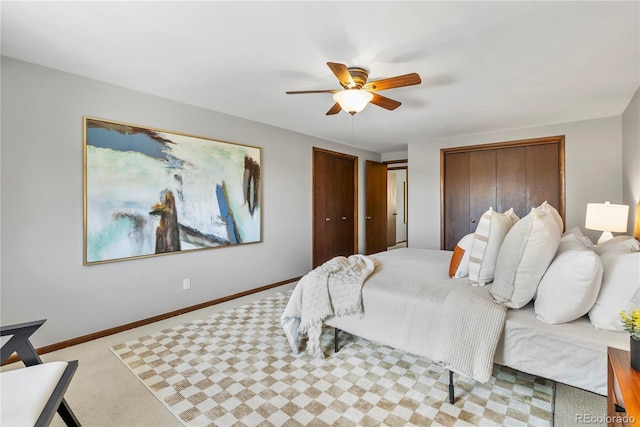 5503 W Colorado Ave, Lakewood, CO 80232 - carpeted bedroom featuring baseboards, a ceiling fan, and two closets