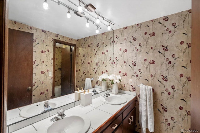5503 W Colorado Ave, Lakewood, CO 80232 - full bath featuring a sink, wallpapered walls, and double vanity