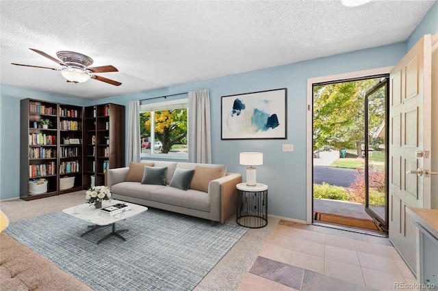 tiled living room featuring ceiling fan and a textured ceiling