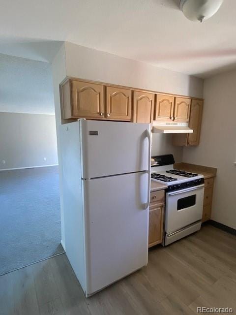 kitchen with light brown cabinets, light hardwood / wood-style flooring, and white appliances