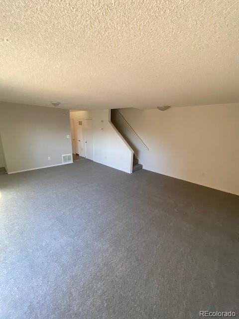 unfurnished living room with a textured ceiling