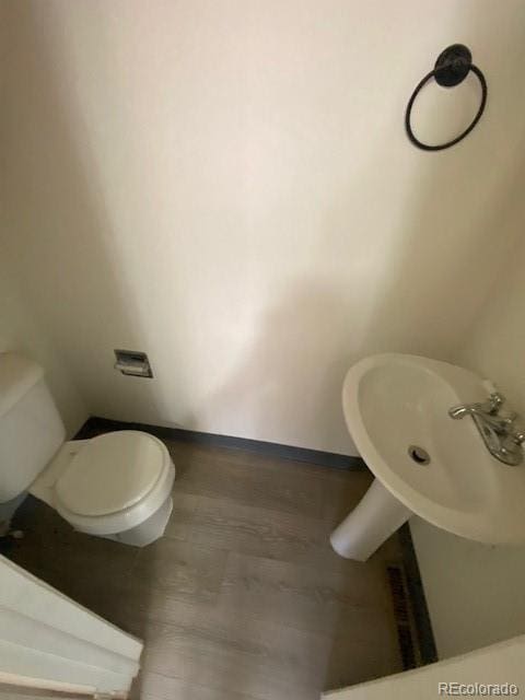 bathroom with hardwood / wood-style floors and toilet