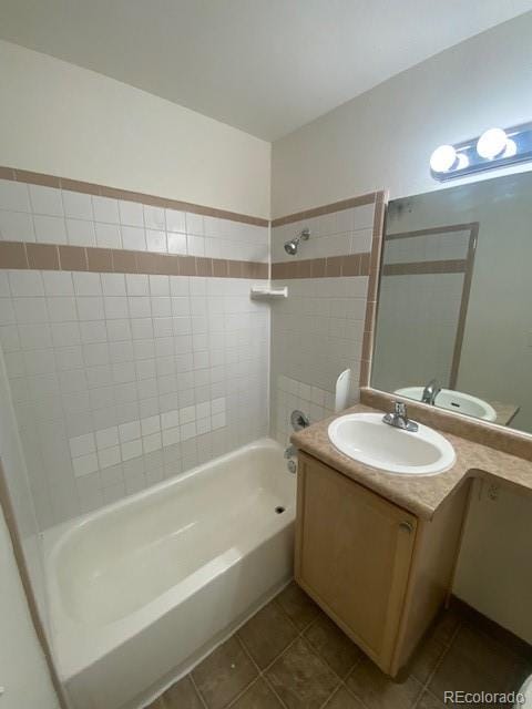 full bathroom with toilet, vanity, tiled shower / bath, and tile patterned floors