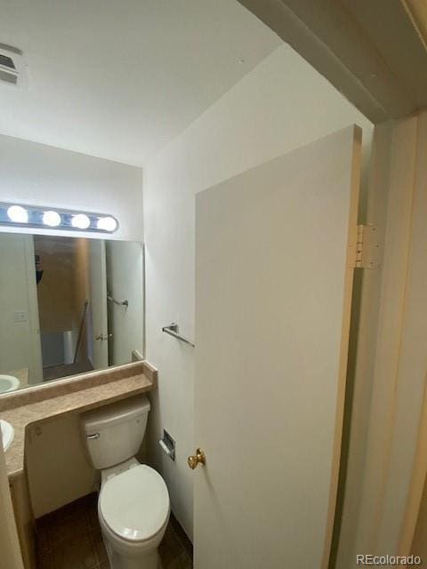 bathroom with toilet and vanity