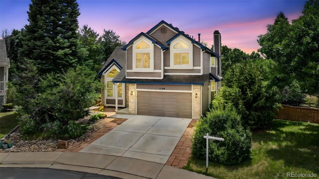 4386 W Deertrail Ct, Castle Rock, CO 80109 - view of front of home with driveway, a garage, and a chimney