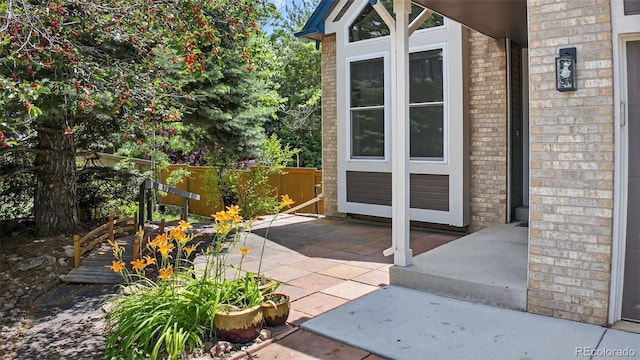 4386 W Deertrail Ct, Castle Rock, CO 80109 - property entrance with brick siding and a patio area
