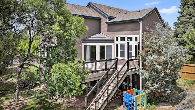 4386 W Deertrail Ct, Castle Rock, CO 80109 - back of house featuring a shingled roof, a deck, and stairs