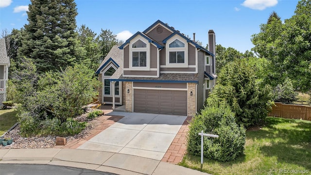 4386 W Deertrail Ct, Castle Rock, CO 80109 - view of front facade featuring brick siding, driveway, a garage, and a chimney