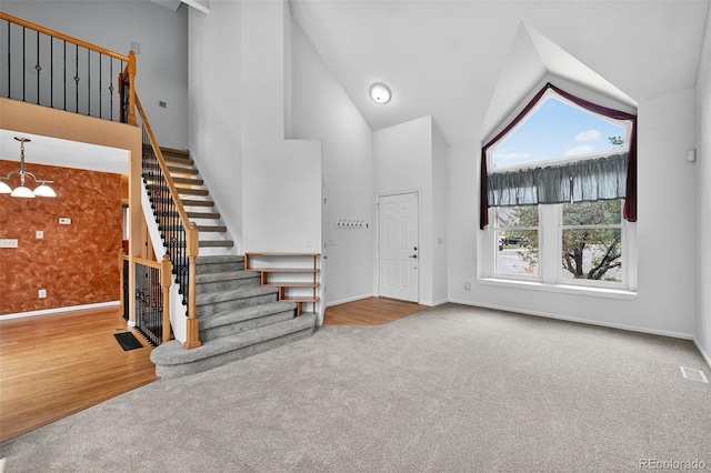 4386 W Deertrail Ct, Castle Rock, CO 80109 - entrance foyer with stairs, carpet floors, high vaulted ceiling, and a chandelier