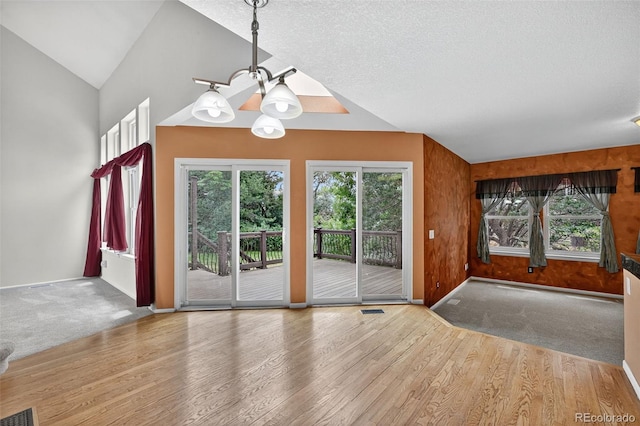 4386 W Deertrail Ct, Castle Rock, CO 80109 - unfurnished dining area with wood finished floors, a chandelier, and vaulted ceiling