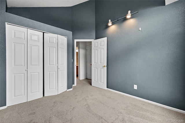 4386 W Deertrail Ct, Castle Rock, CO 80109 - unfurnished bedroom with carpet floors, a closet, and high vaulted ceiling
