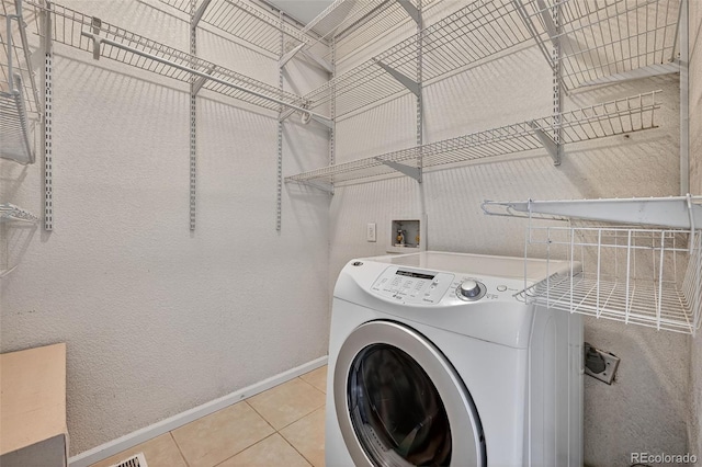 4386 W Deertrail Ct, Castle Rock, CO 80109 - laundry area with washer / dryer and light tile patterned floors