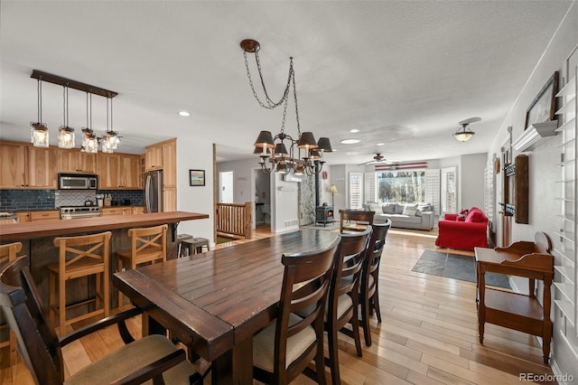 dining room featuring recessed lighting, a ceiling fan, and light wood-style floors