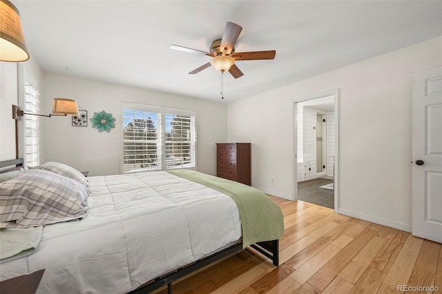 bedroom featuring ceiling fan, ensuite bath, light wood-style flooring, and baseboards