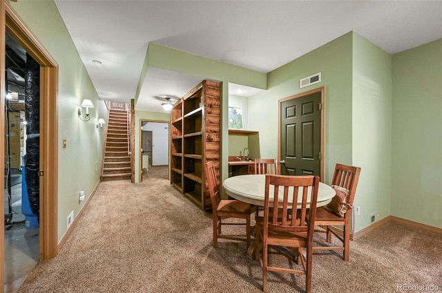 dining space with stairway, baseboards, visible vents, and carpet flooring