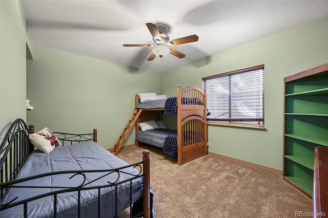 bedroom with ceiling fan, baseboards, and light colored carpet