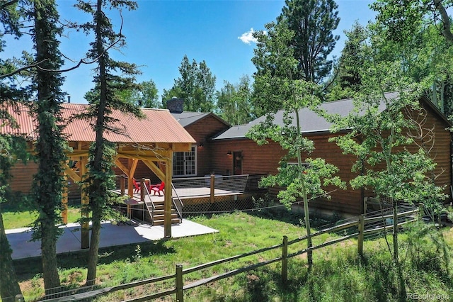 view of jungle gym with a wooden deck, fence, and a yard