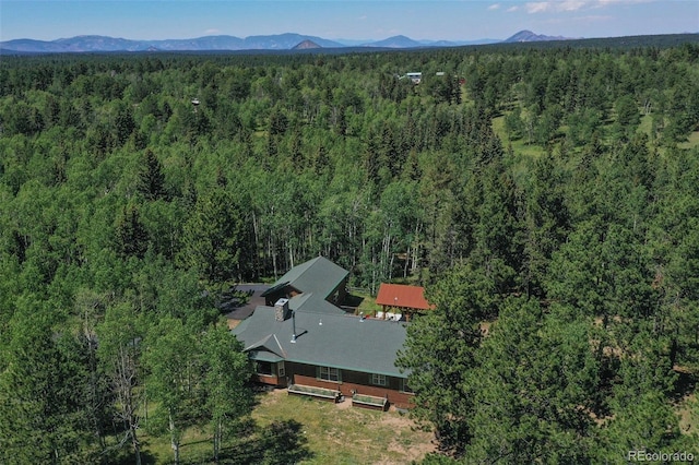 drone / aerial view with a mountain view and a wooded view