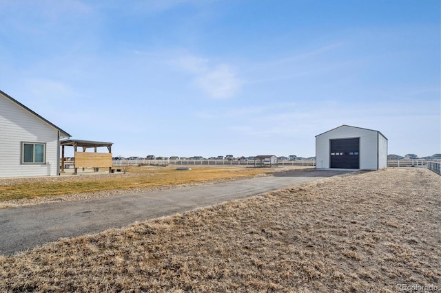 view of yard featuring an outdoor structure and fence