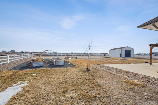 view of yard with a garden, fence, and an outdoor structure