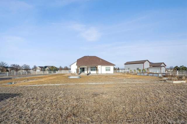 view of front of property featuring an enclosed area and fence